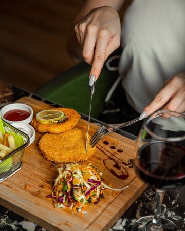 chicken schnitzel with vegetables and sauceの写真素材