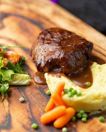 meat medallion in its juice with mashed potatoesの写真素材