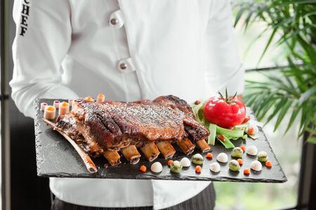 fried ribs with fresh tomatoの写真素材