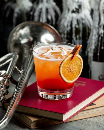 Orange drink with a slice of orange on a stilettoの写真素材