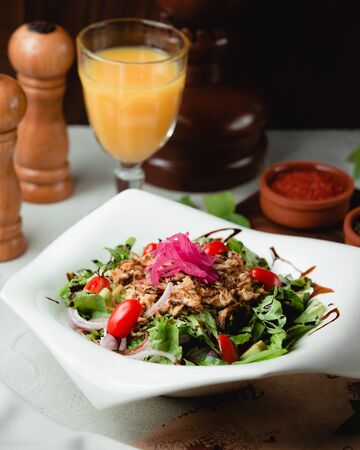 Chicken salad with vegetables in the plateの写真素材