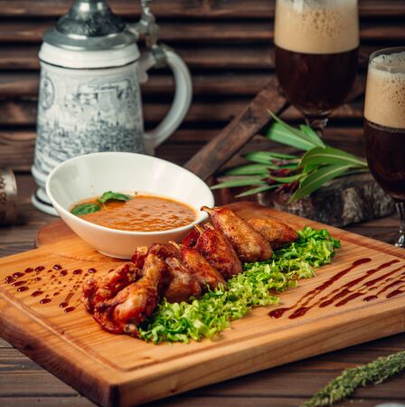 Chicken wings with sauce on the tableの写真素材