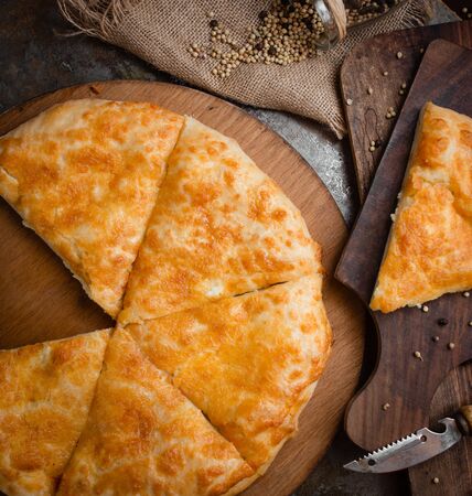Georgian xachapuri with cheese on wooden boardの写真素材