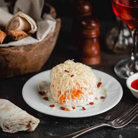 Mimoza salad with pomegranate in the plateの写真素材