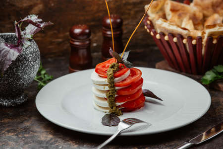 Carpese salad with tomato and mozzarella slices and balsamic sauceの写真素材