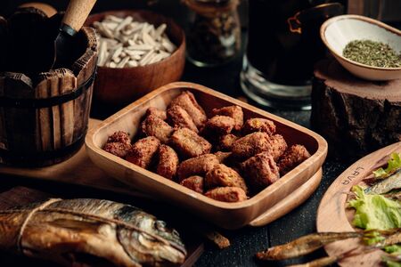 Chicken nuggets as beer snack on wooden plateの写真素材