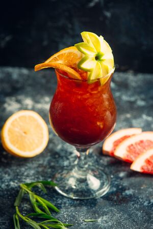 Grapefruit juice with ice shavings, orange and apple flower decorの写真素材