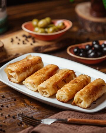 Fried meat wraps as a side dish for dinner with olivesの写真素材