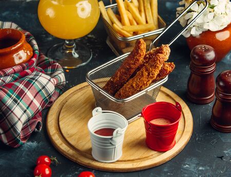 Chicken croquettes served with french fries, mayo and ketchupの写真素材