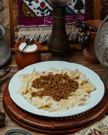 Khingal noodle sheets with fried minced meat and yogurtの写真素材
