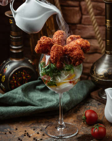 Fried crispy shrimp cocktail with parsley in a glassの写真素材