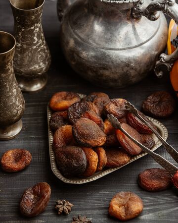 Dried fruit dried peaches in vintage triangle bowl in rustic styleの写真素材