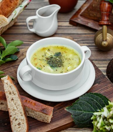 Dushbara dumpling soup served with bread on wooden tableの写真素材