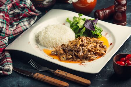Sauteed mushroomwith rice and fresh salad on white plateの写真素材