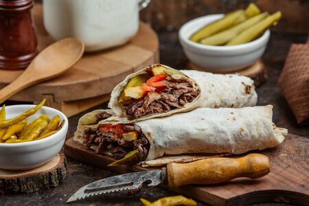Grilled beed wrap doner with cucumber prinkles, tomato and friesの写真素材