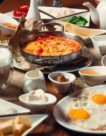 Traditional turkish breakfast with sunny side up eggs, nutella, egg dish menemenの写真素材