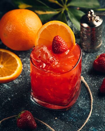 Red strawberry juice with ice strawberry and orange sliceの写真素材