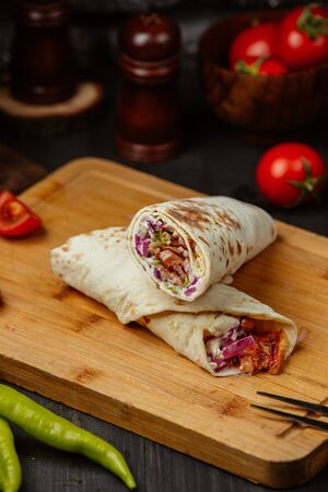 Chicken doner wrap with lettuce, mayo, tomato and fresh herbsの写真素材