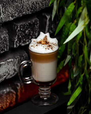 A cup of coffee with milk and whipped creamの写真素材