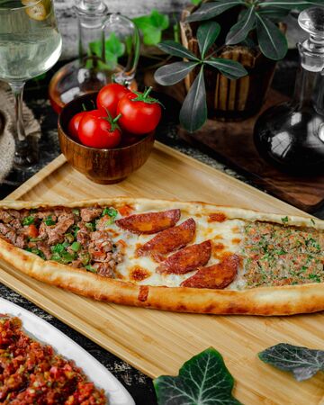 Mixed pide filled with sausage, cheese and meatの写真素材
