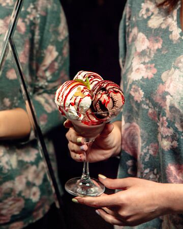 Mixed ice cream cups topped with syrupの写真素材