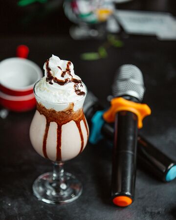 Coffee milkshake topped with whipped creamの写真素材