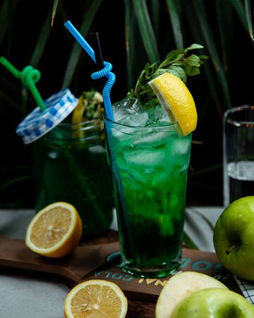 Ice tea with greenery and lemonの写真素材