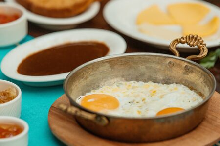 close up of sunny side up eggs in turkish copper pans for breakfastの写真素材