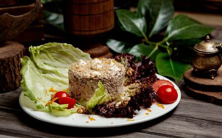 chicken salad with walnut and mayonnaise served with lettuce leaves and tomatoの写真素材