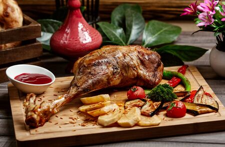 fried sheap leg on wooden boardの写真素材