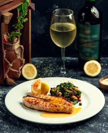 fried salmon with vegetables on the tableの写真素材