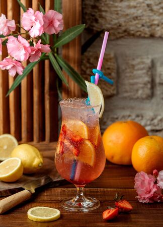 fruit cocktail with orange and strawberry garnished with lemonの写真素材