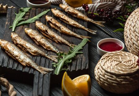 fried fish set on wooden boardの写真素材