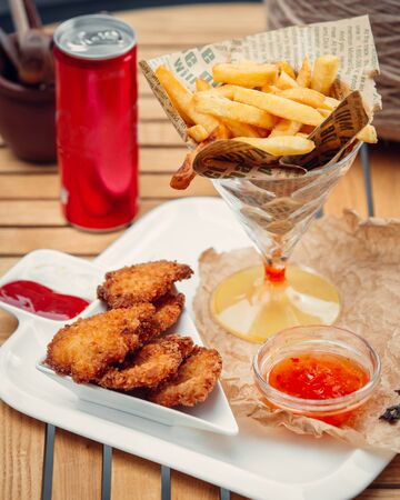 triangular nugget bowl served with fresh fries and sweet chili sauceの写真素材