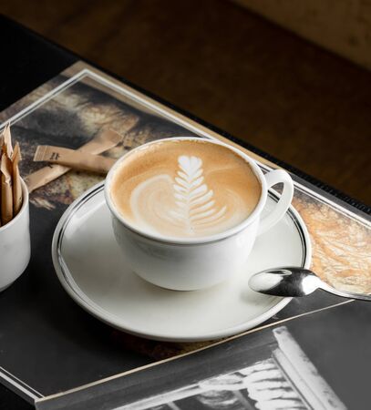 a cup of cappuccino with rosetta latte artの写真素材