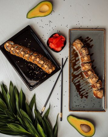 takeaway platter and serving platter with hot and sushi rollsの写真素材