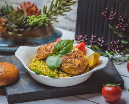 fried chicken with rice tomato and lemonの写真素材