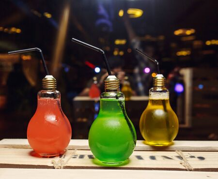 various color cocktails in lamp bottles