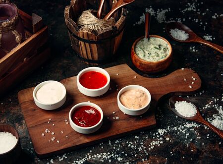 various sauces on wooden boardの写真素材