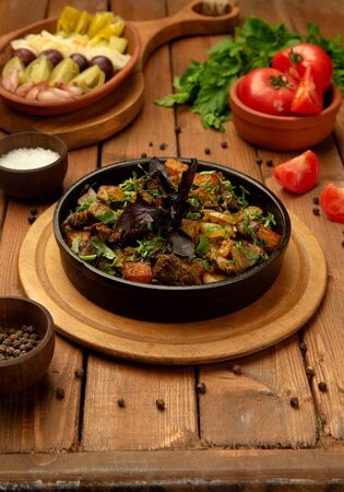 roasted lamb in cast iron bowl garnished with fresh herbsの写真素材