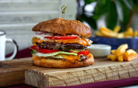 close up of beef burger served on wood boardの写真素材
