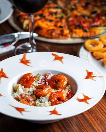 caesar salad with shrimps in sweet chili sauce, lettuce andの写真素材