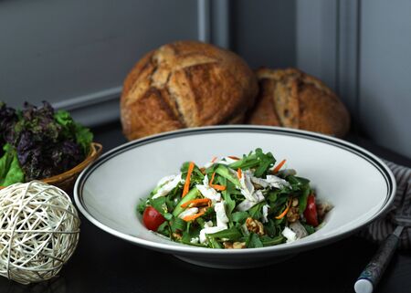 fresh vegetable salad with arugula, cheese, walnut, carrot, cucumber andの写真素材