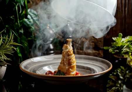 lamb leg covered with crispy dough, cooked with vegetablesの写真素材