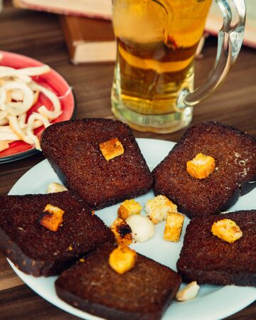 fried black bread with garlic and beerの写真素材