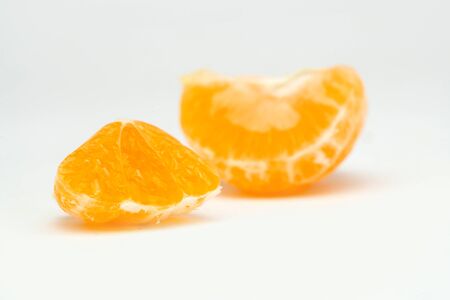 fresh pieces of tangerine on the tableの写真素材