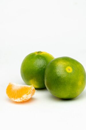 fresh green tangerines on the tableの写真素材