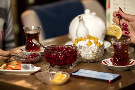 berries jam with black tea on the tableの写真素材