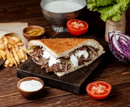doner in fresh bread with meat dressed with mayonnaise