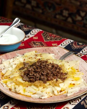 azerbaijani khinkali with meat sauce and fried onionsの写真素材